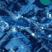 Aerial view of a smart manufacturing plant with digital supply chain network connections and data analytics icons.
