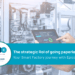 Engineer using a digital tablet on a smart factory shop floor, illustrating paperless manufacturing enabled by Epicor Kinetic.