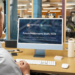 Person viewing the Future Newsrooms Study 2026 on a desktop screen in a modern newsroom office.